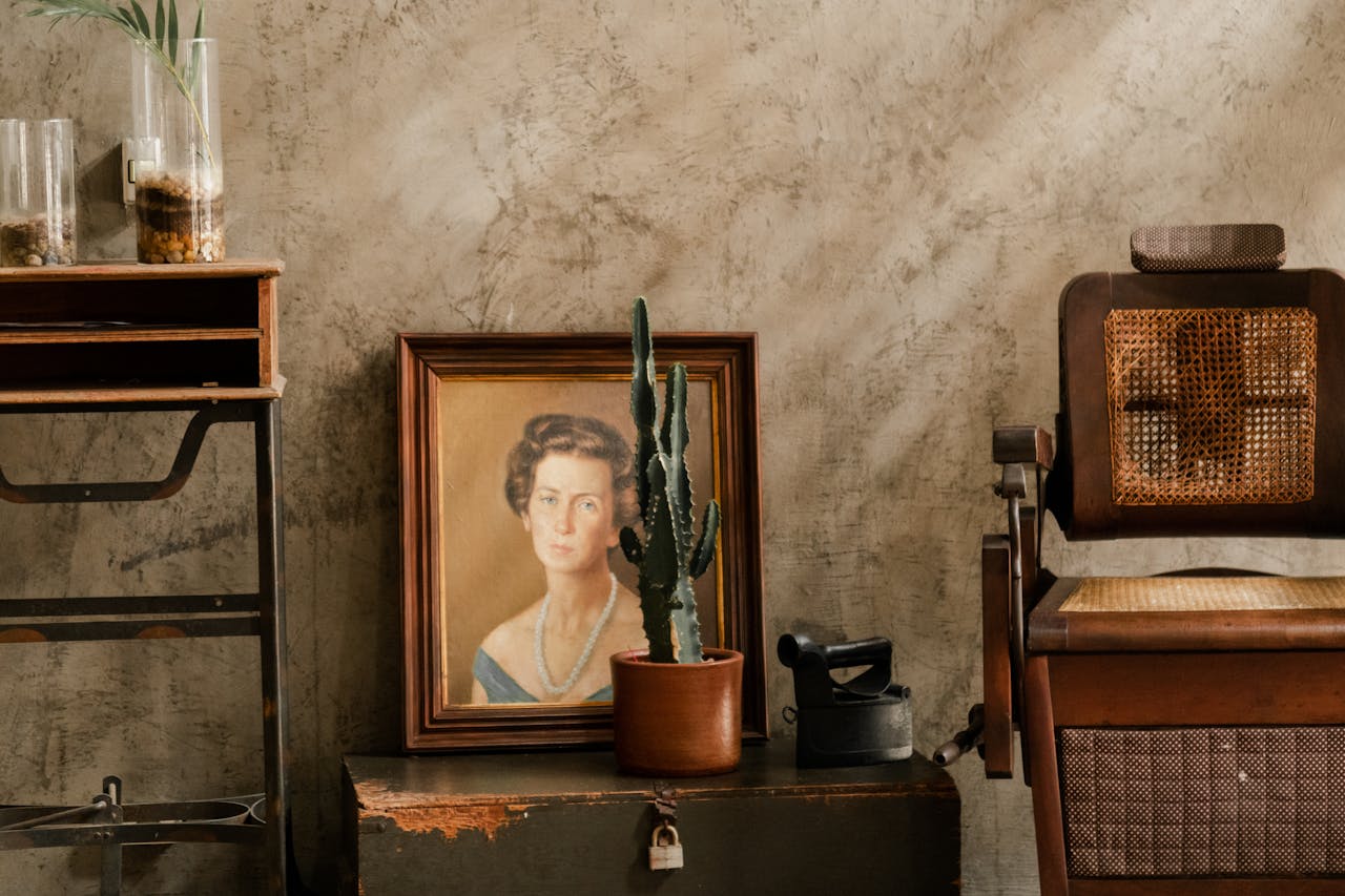 our-experience Antique decor in a vintage room featuring a cactus, portrait, and wooden chair.