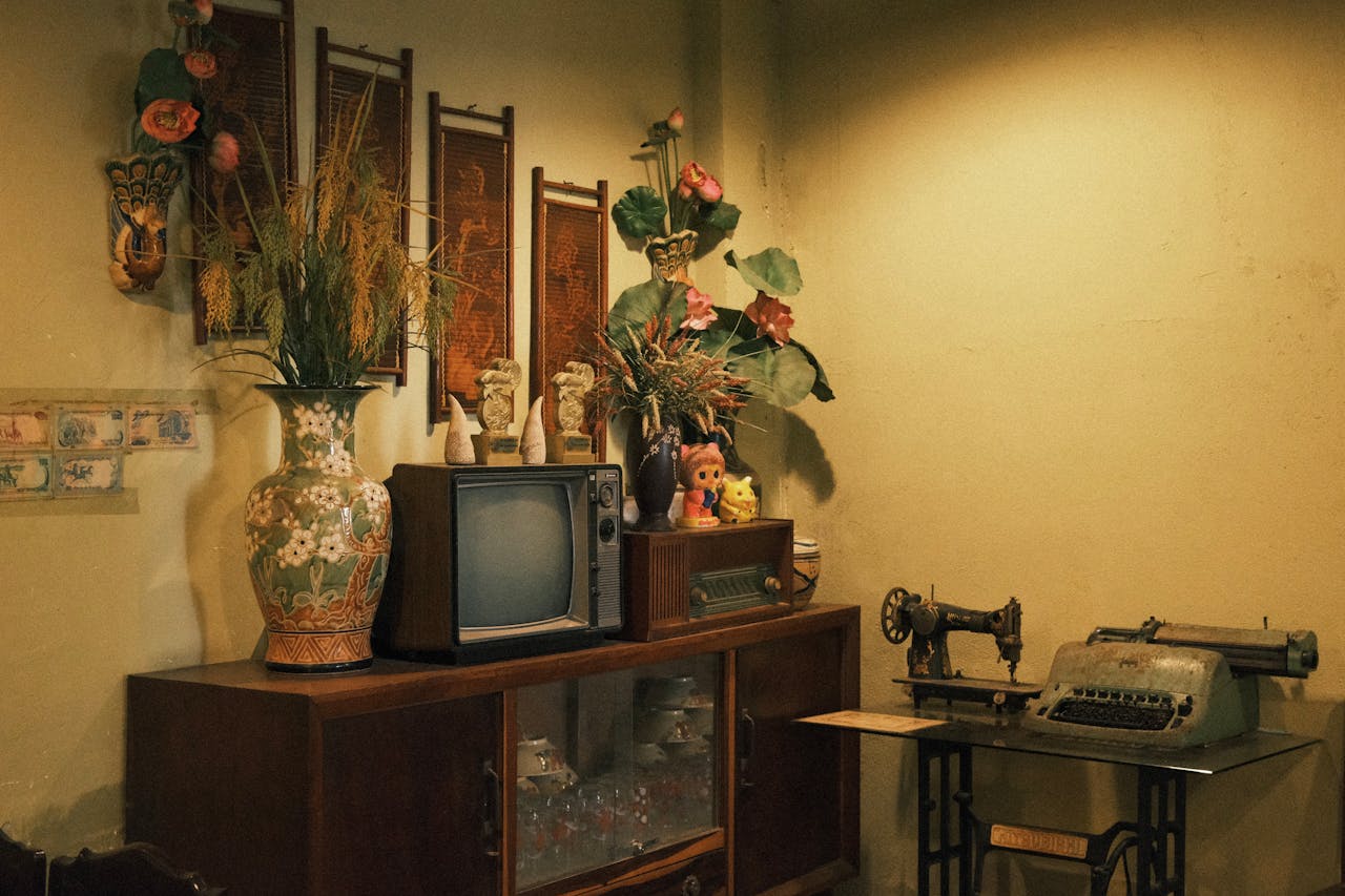 services-01 Nostalgic vintage room with retro TV, flowers, and typewriter.